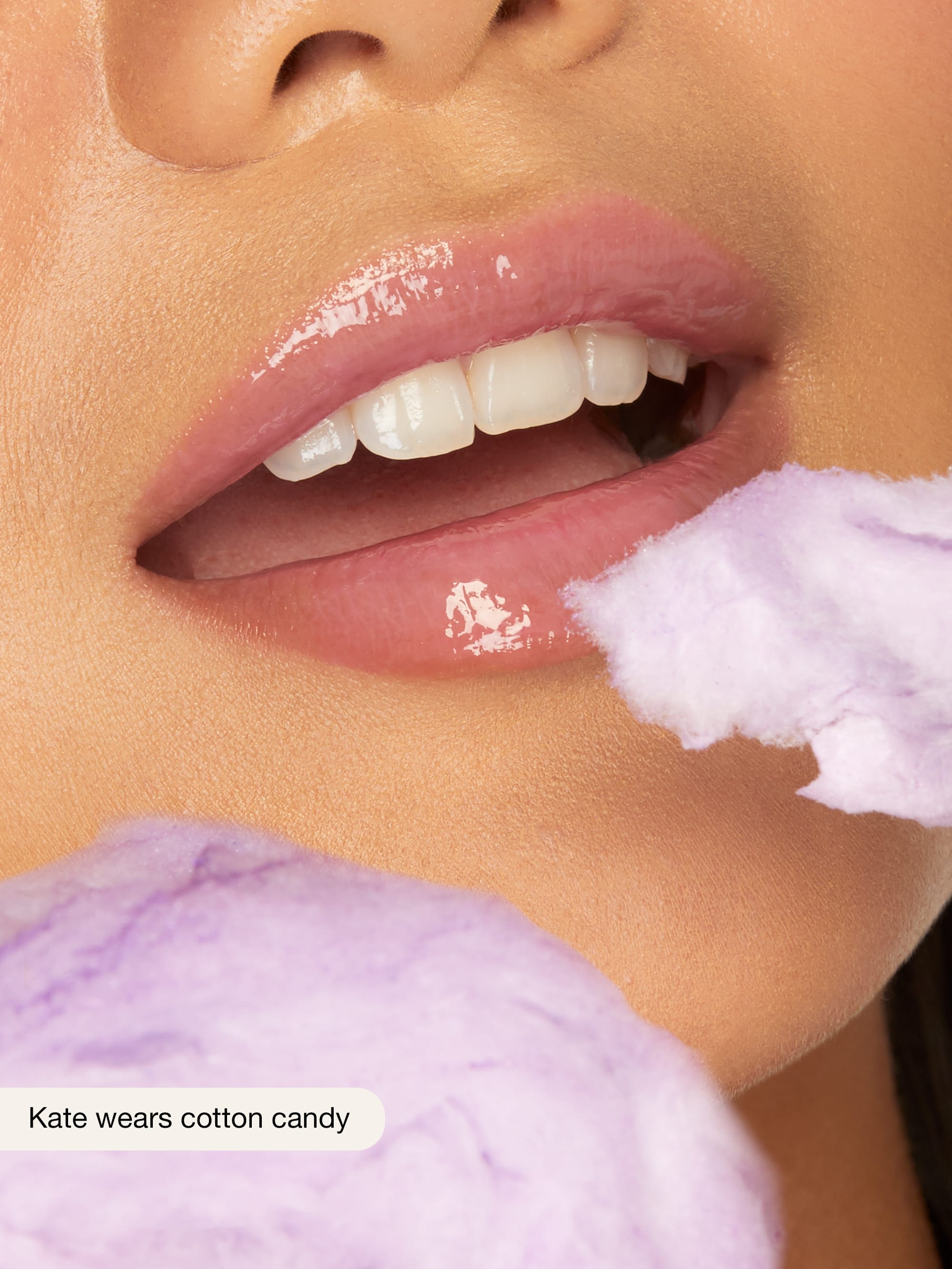 Close-up of a person's lips with cotton candy on a blurred background