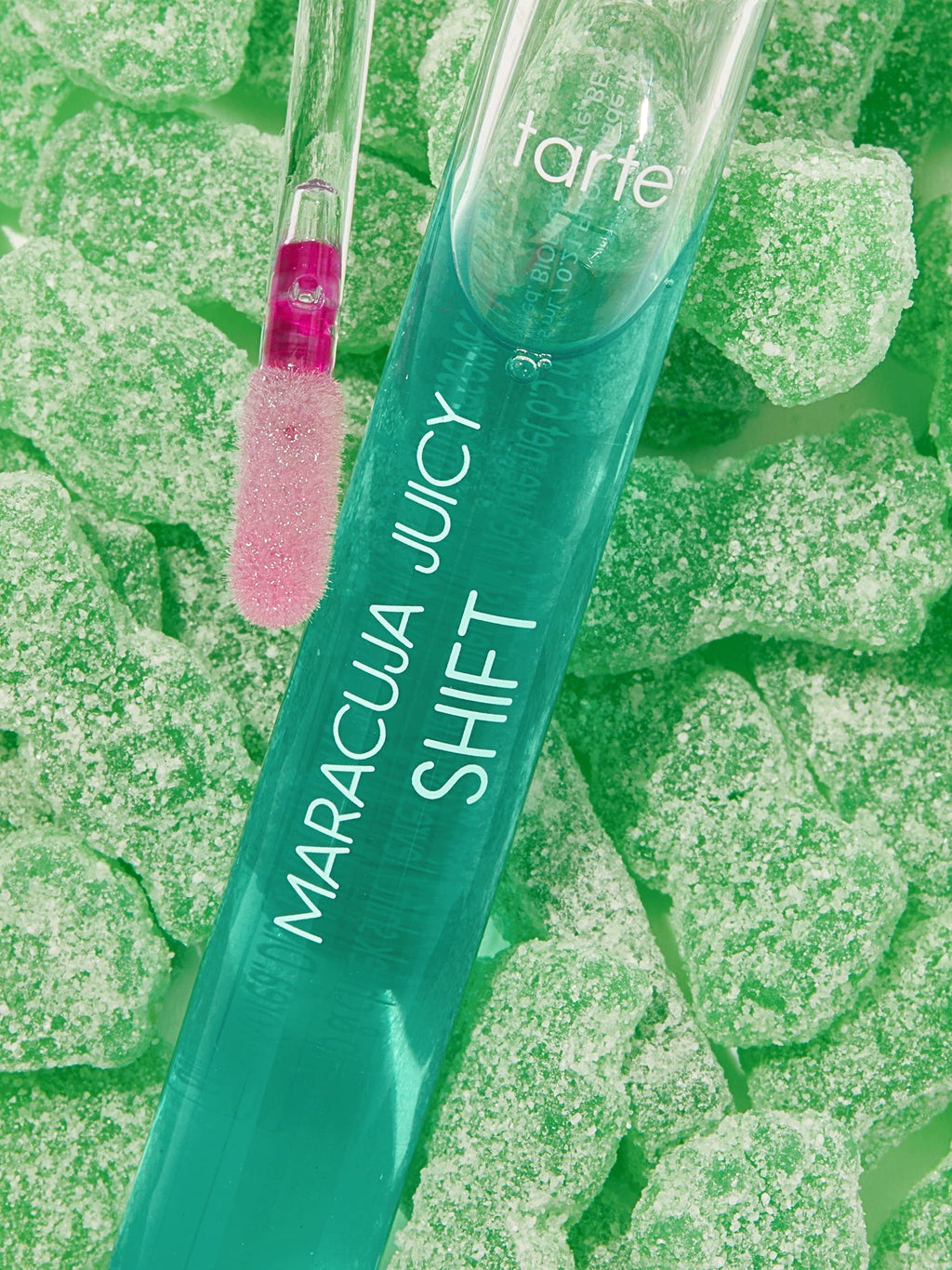 Tarte Maracuja Juicy Shift makeup product on a green textured background
