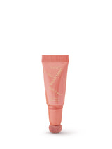 Pink lip balm tube on a white background