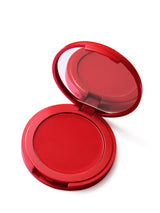 Red compact blush with mirror on a white background