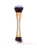 Makeup brush with gold handle and black bristles on a white background