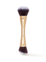 Makeup brush with gold handle and black bristles on a white background