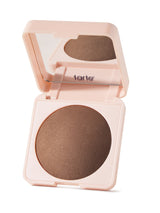 Open tarte bronzer compact with brown powder on a white background