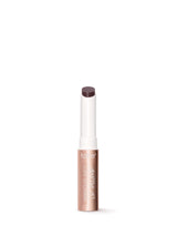 Lip plumper with white cap and visible brand name on a white background