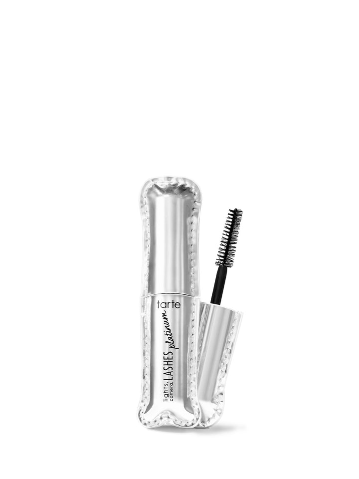 A travel-size tarte mascara with the wand applicator next to the tube, showcasing the clear serum formula.