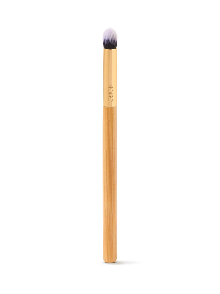 Makeup brush with a wooden handle on a white background