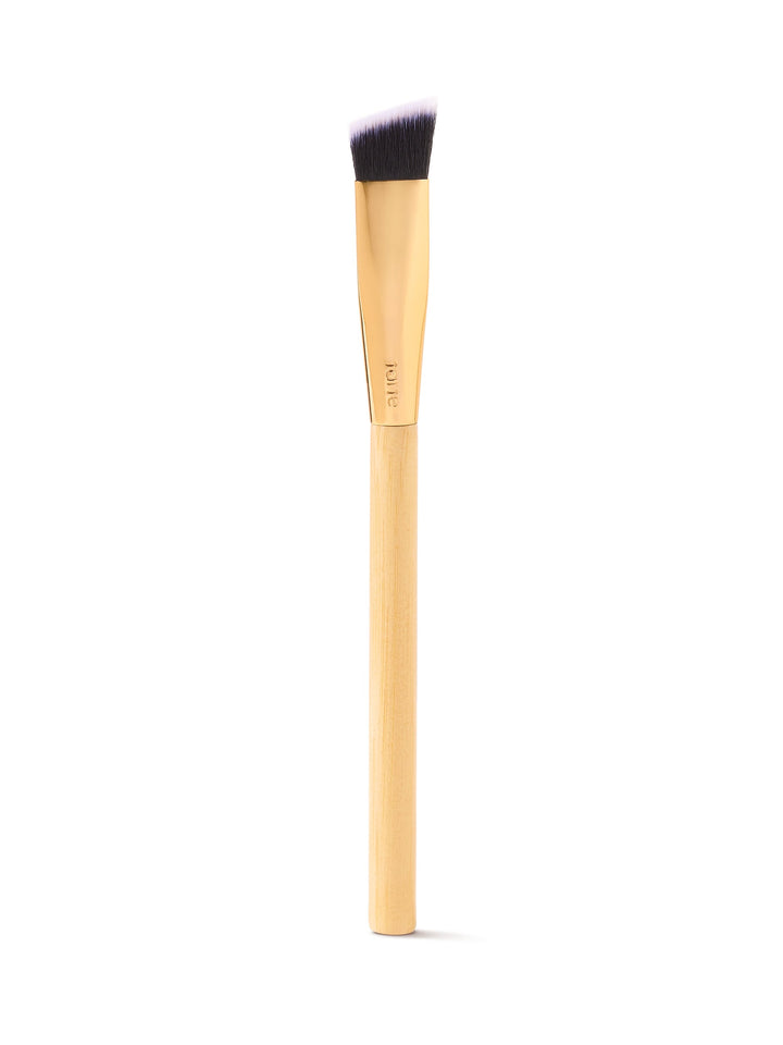 Makeup brush with wooden handle and black bristle head on a white background