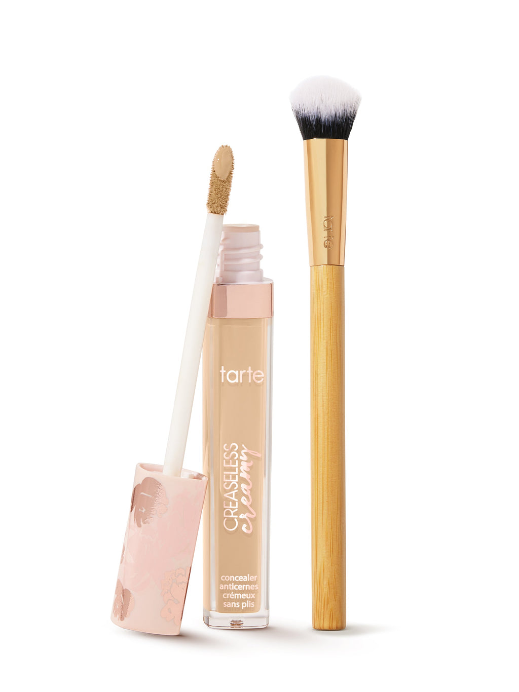 tarte creaseless creamy concealer  with applicator and brush on a white background