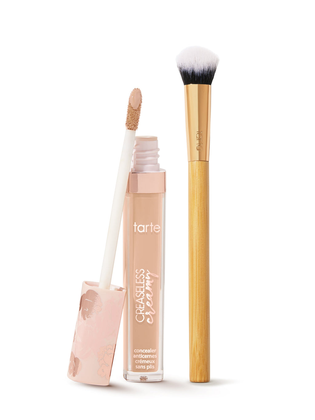 tarte creaseless creamy concealer  with applicator and brush on a white background