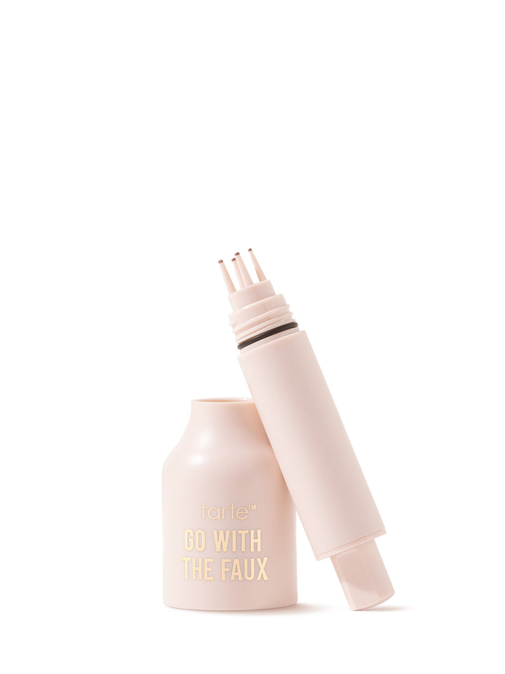 Light-pink Tarte eyebrow pencil lies uncapped on a white background; cap set beside, exposing an angled tip and slim barrel. Text on product: tarte