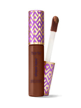 Mascara with purple and gold patterned casing and brush on a white background