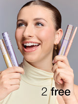 Woman holding makeup products with promotional text on a gray background