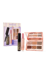 A set of Tarte Cosmetics featuring: a mascara labeled MANEATER in a leopard-patterned design, a LIP PLUMP stick in pink, and an open eyeshadow palette with six shades titled irresistible, mesmerizing, captivated, tempting, lovestruck, enticing. The backdrop showcases its packaging labeled Tarte kindness cafê est. '99 and maneater plumped travel must-have essentials.