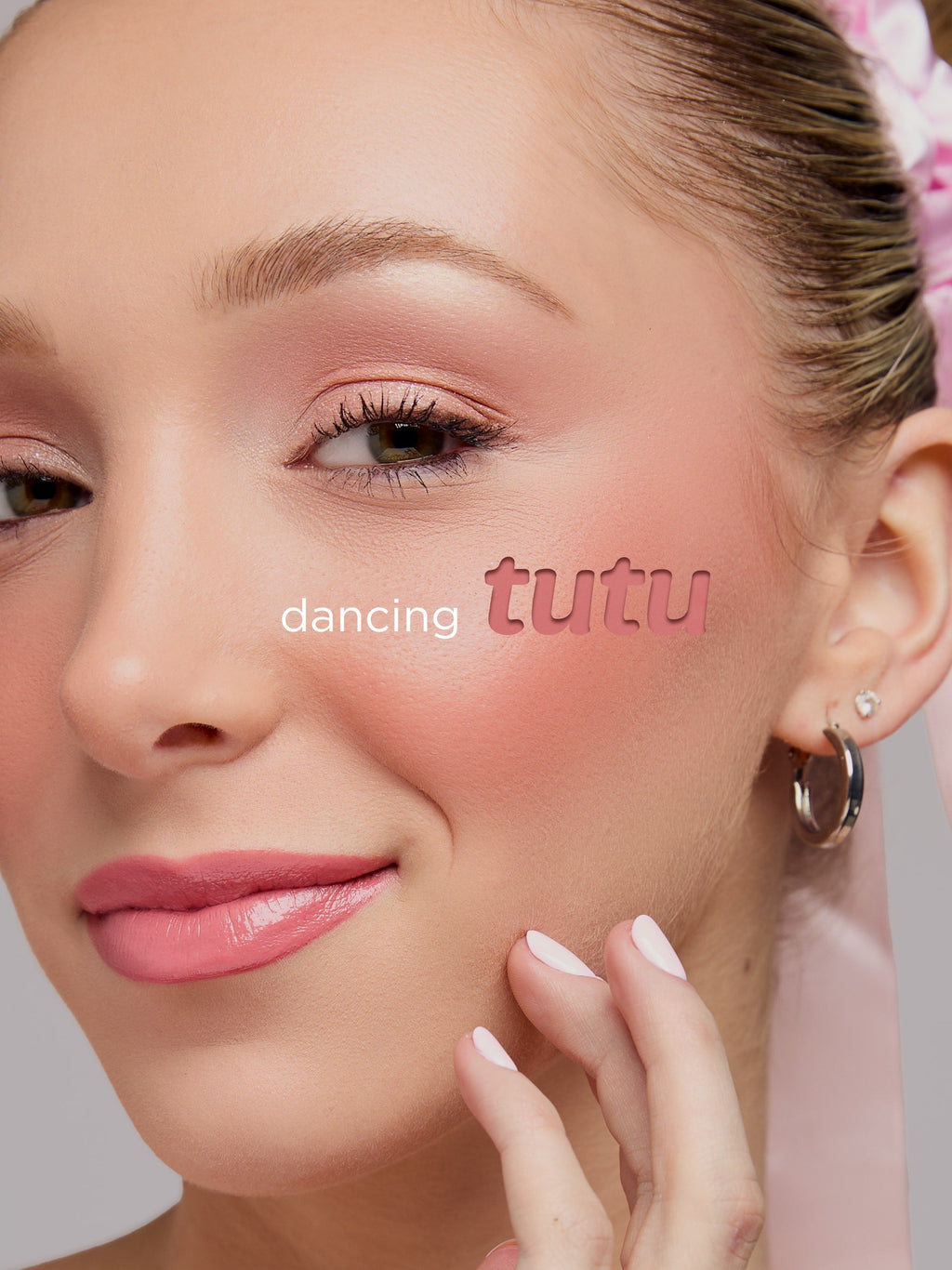 Close-up of a woman's face with 'dancing tutu' text overlay on a light background