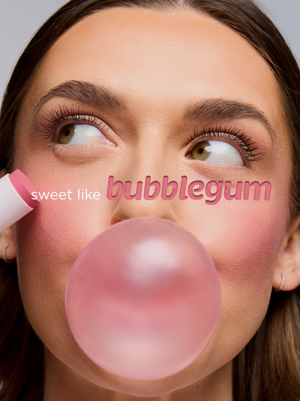 Woman blowing a bubble of bubblegum with text 'sweet like bubblegum' on a gray background