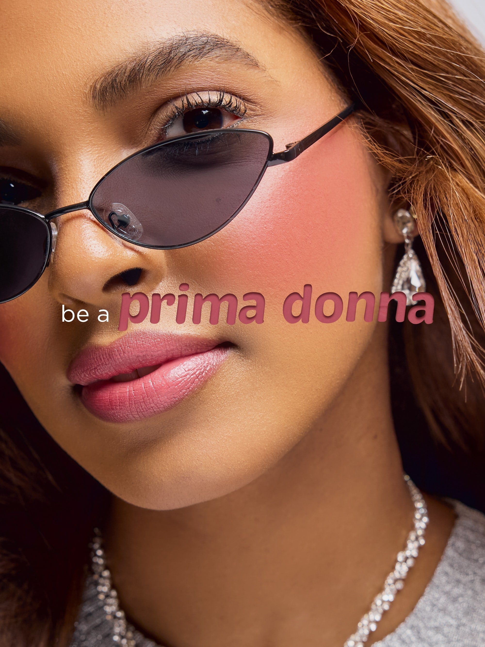 Close-up of a person wearing sunglasses with 'be a prima donna' text overlay.
