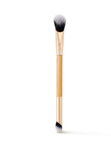 Makeup brush with gold handle and black bristles on a white background