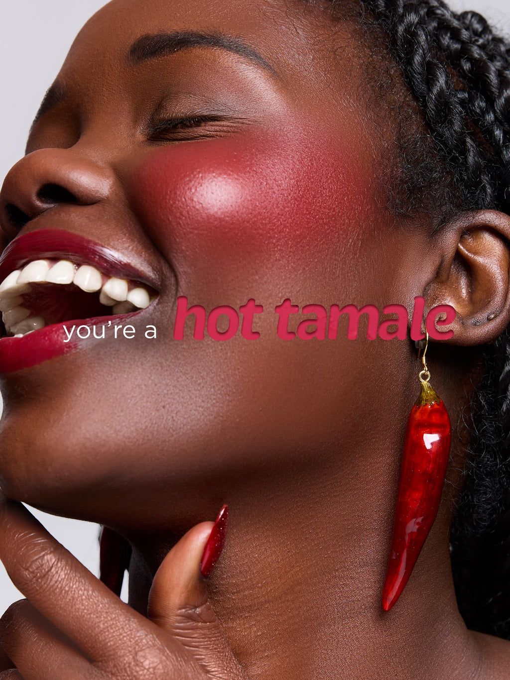 Woman with red lipstick and earrings, with text 'you're a hot tamale' on a white background