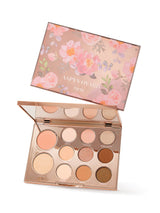 Makeup palette with floral design on the lid, featuring the brand 'Tarte'.