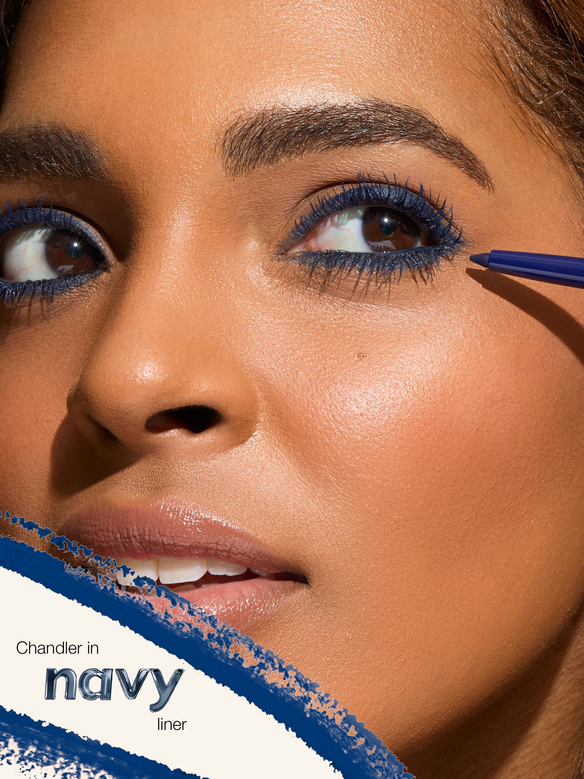 Close-up of a person applying blue eyeliner with a brush, featuring the brand 'Chandler' in 'navy liner'.