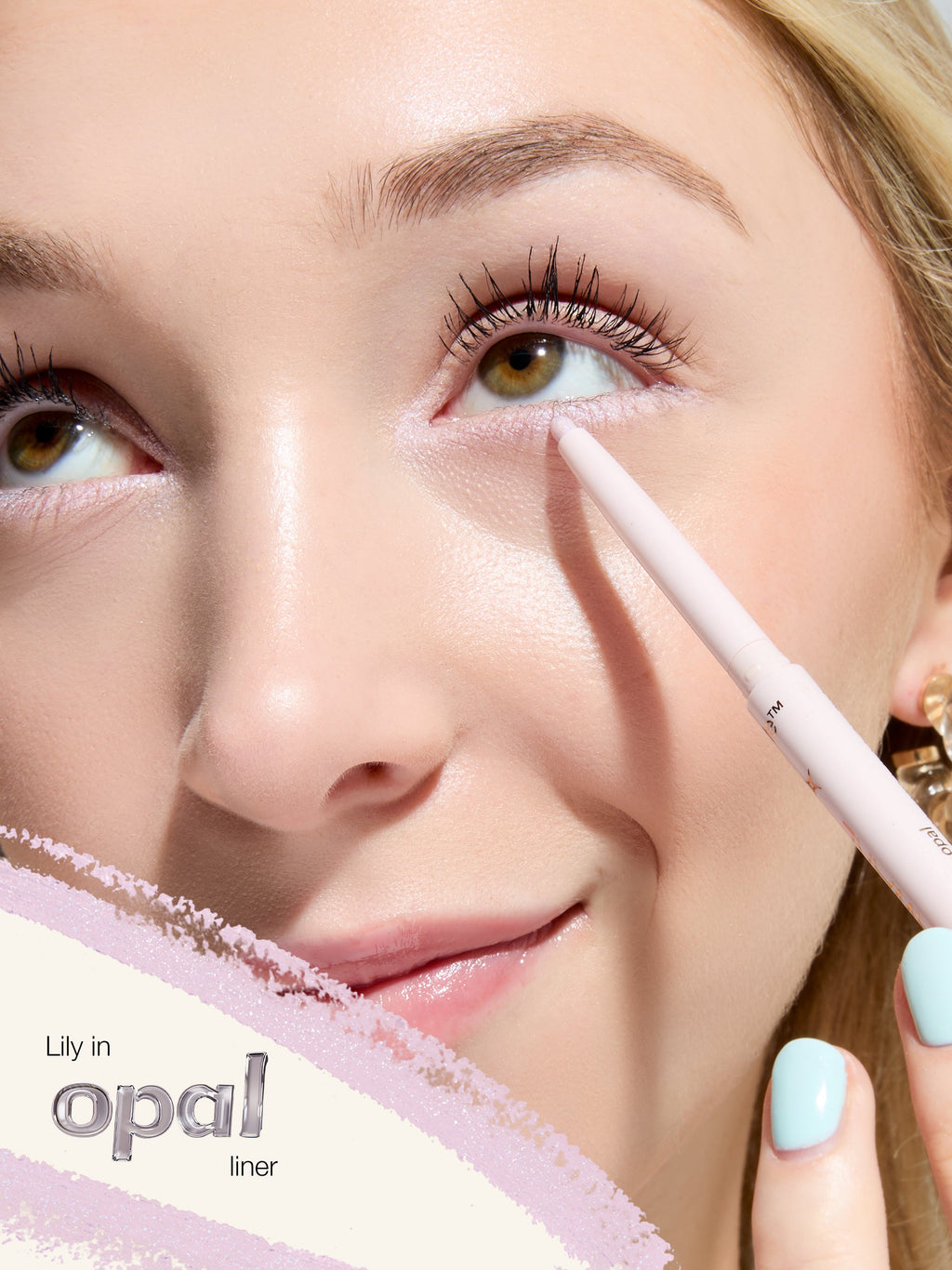 Woman applying eyeliner with a pencil, focusing on eye makeup.