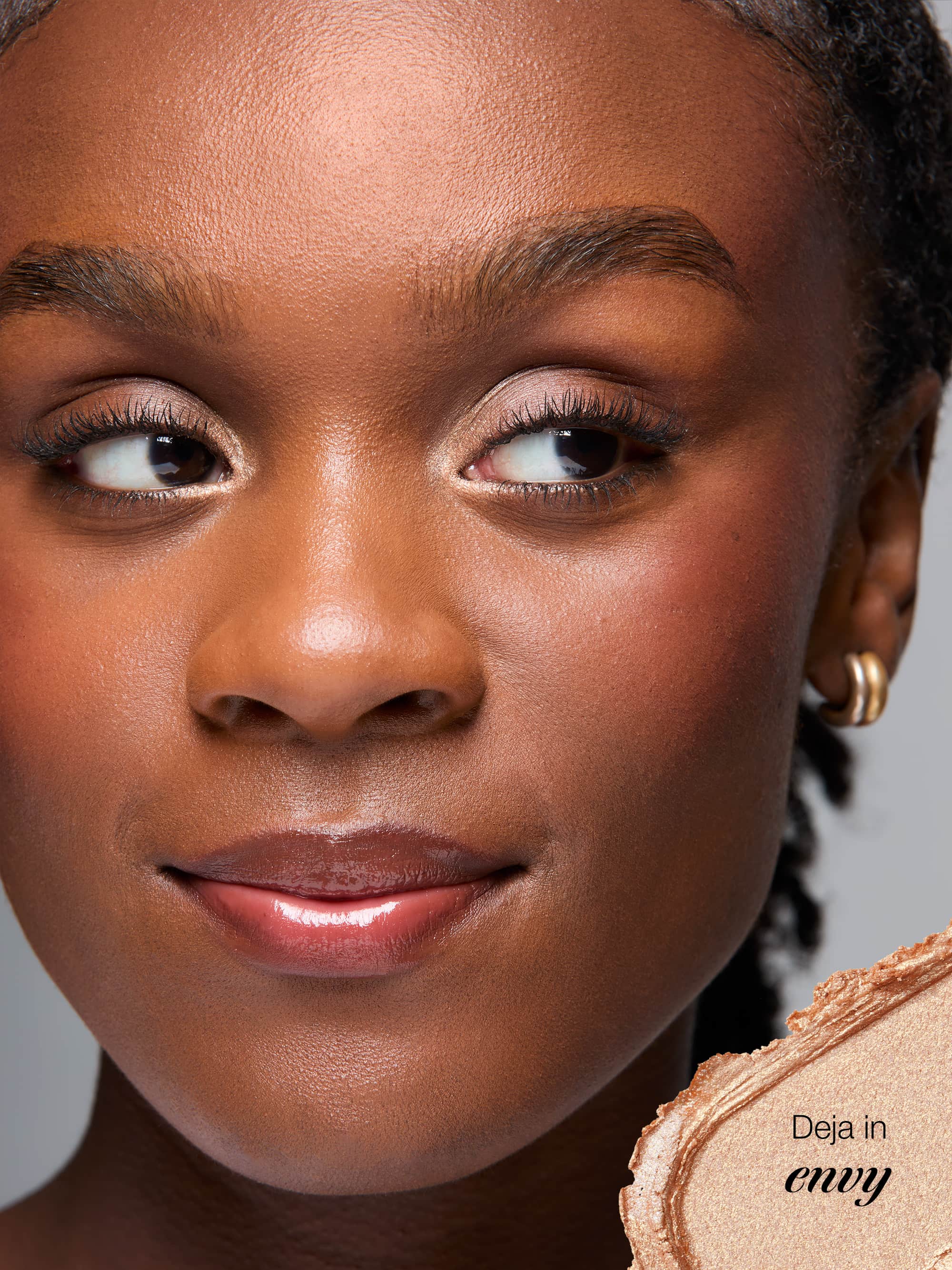 Close-up of a woman's face with makeup product, featuring 'Deja' brand.
