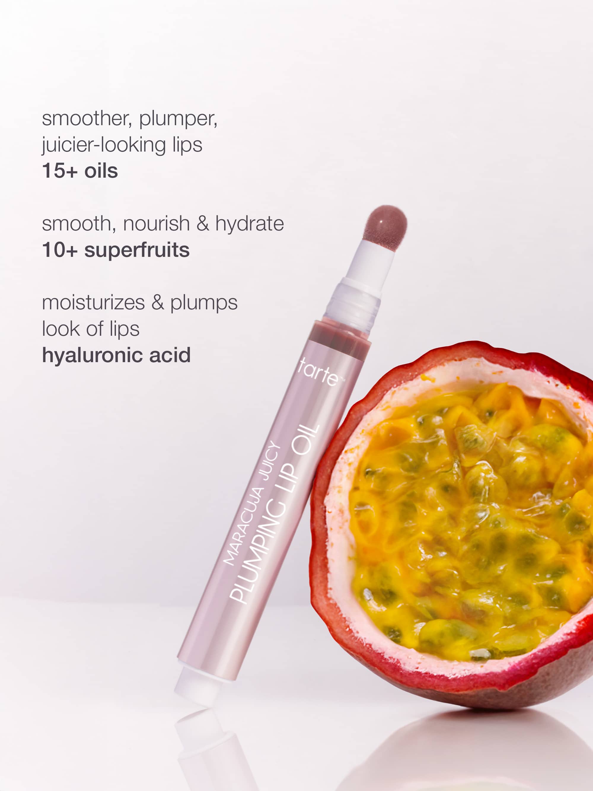 Tarte lip oil with a passion fruit on a white background
