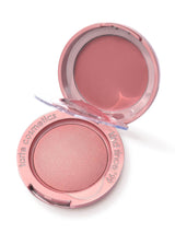 Tarte Macaron Blush Duo compact blush sits open, revealing shimmery pressed powder in the base and a cream pan in the lid on a white background. Text on rim: tarte cosmetics; kind since 99.