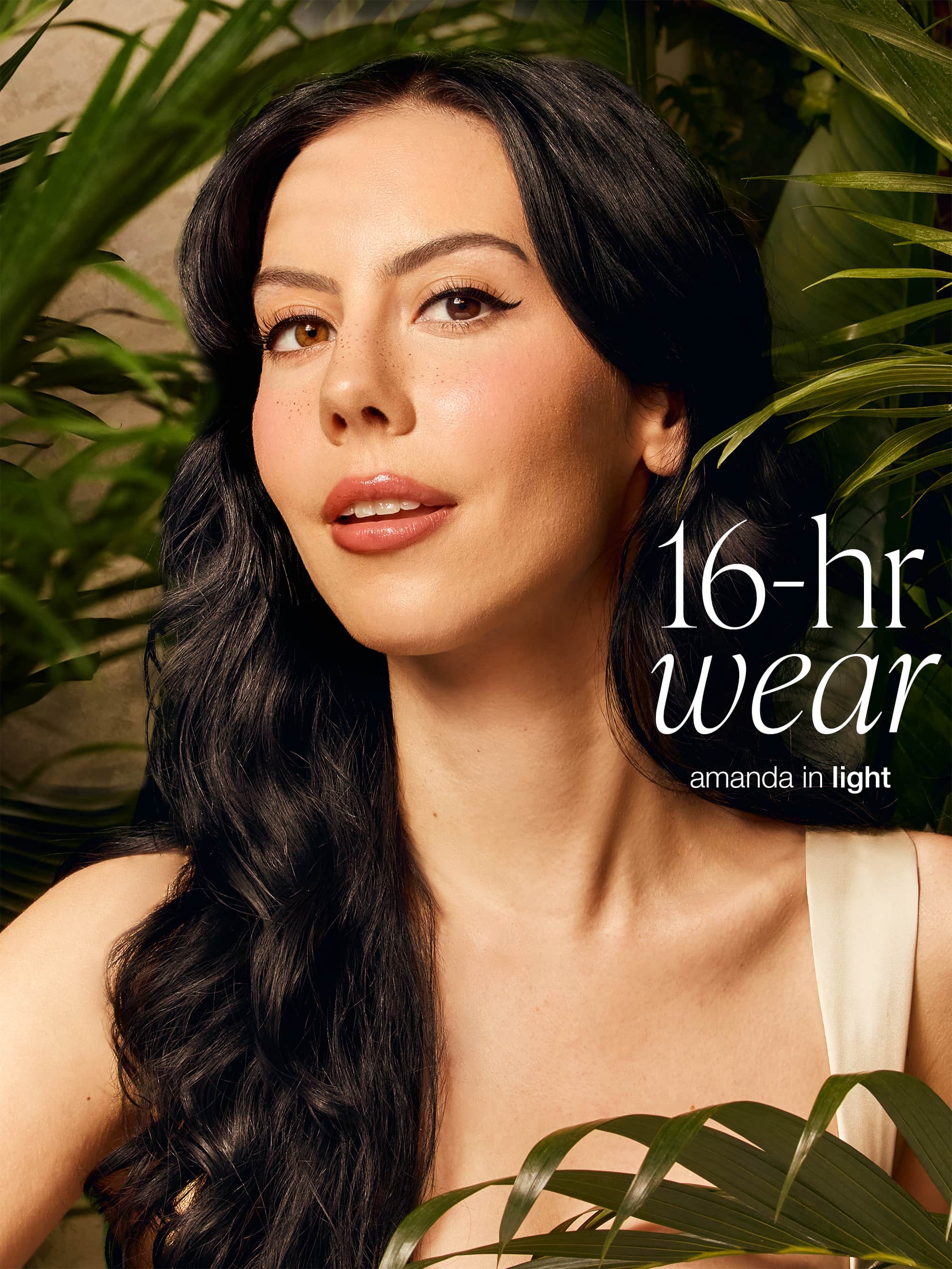 Woman with long dark hair surrounded by greenery with text '16-hr wear' and 'amanda in light' wearing tarte CC serum 