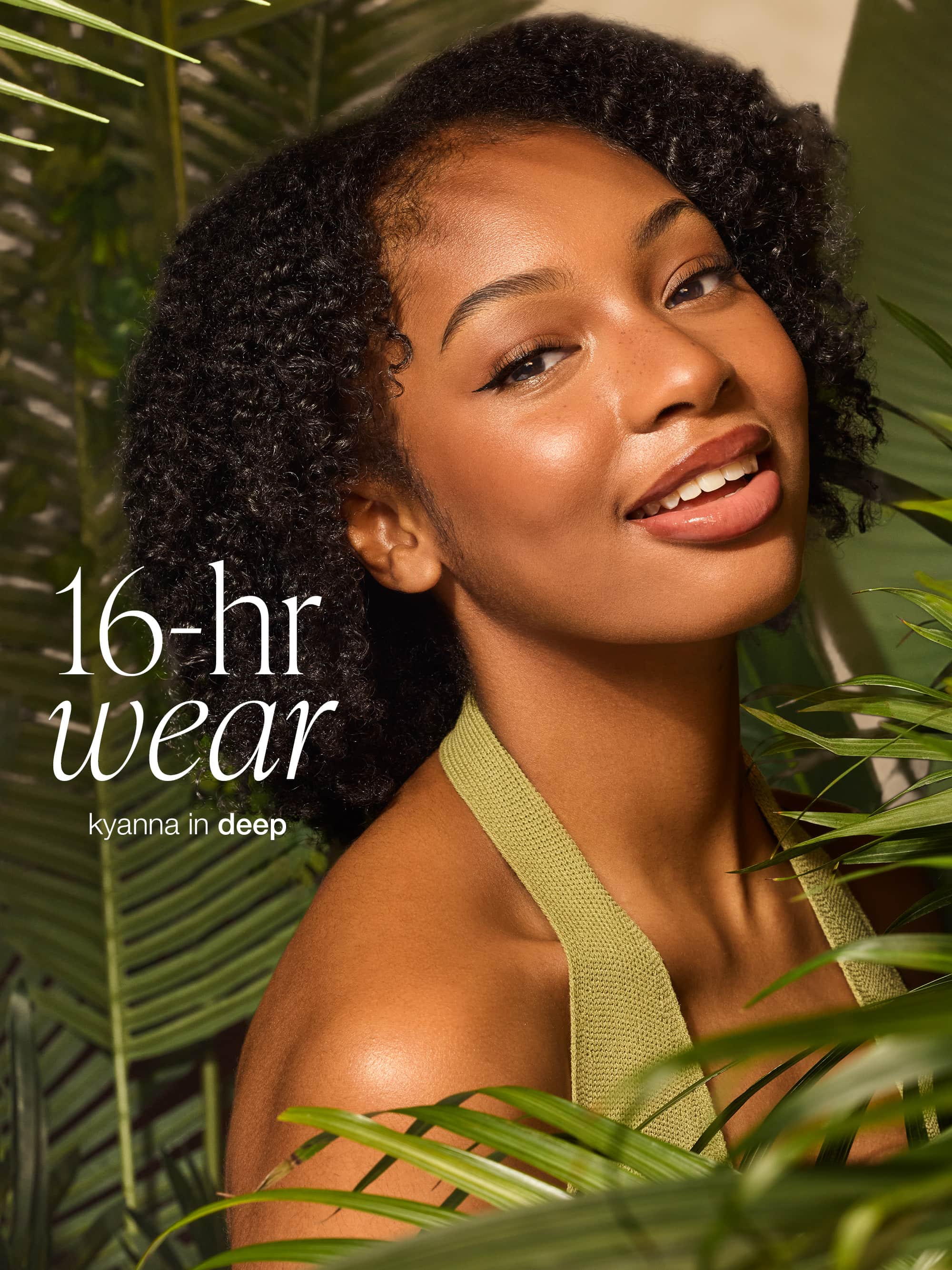 Woman with natural hair surrounded by green leaves with text '16-hr wear kyanna in deep' wearing tarte CC serum 
