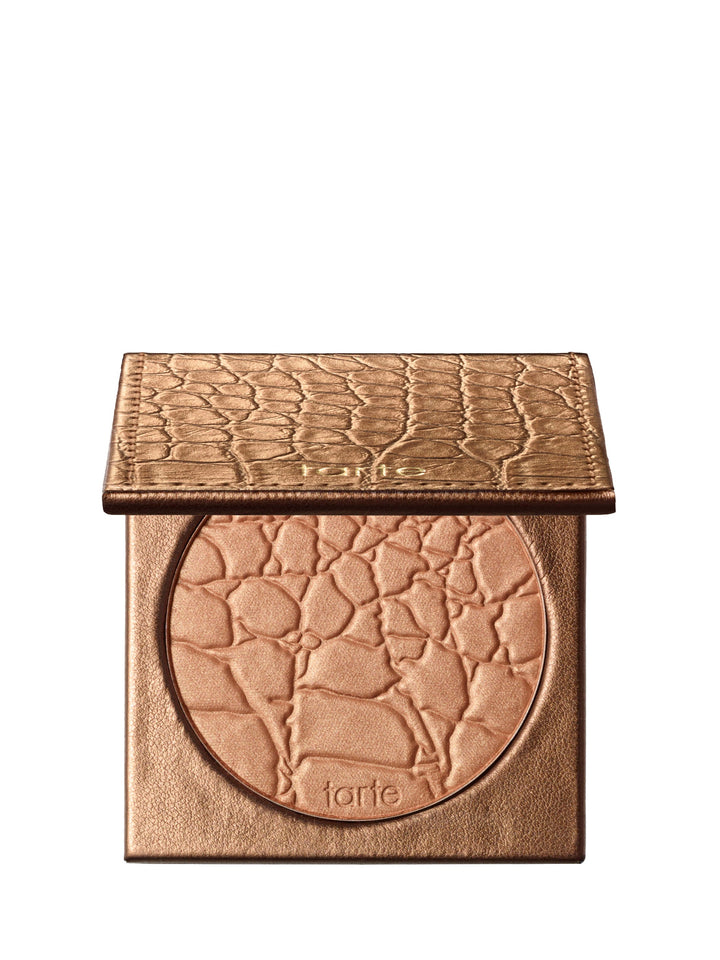 Bronze-colored makeup compact with 'tarte' branding on a white background