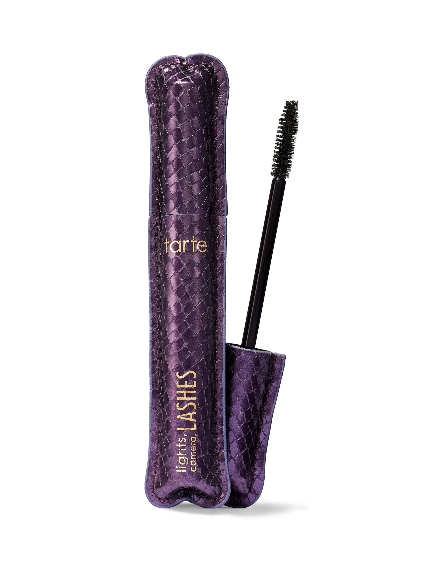 A container of tarte lights, camera, lashes 4-in-1 mascara with the wand applicator shown outside. The container is purple with a quilted design.