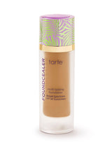 Tarte foundation bottle with a colorful cap on a white background