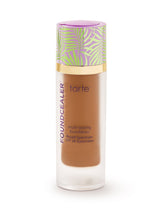 Tarte multi-essence foundation bottle with colorful cap on a white background