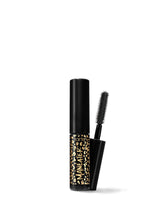 A travel-size mascara with a black tube and a brush applicator, featuring a gold and black pattern on the tube.