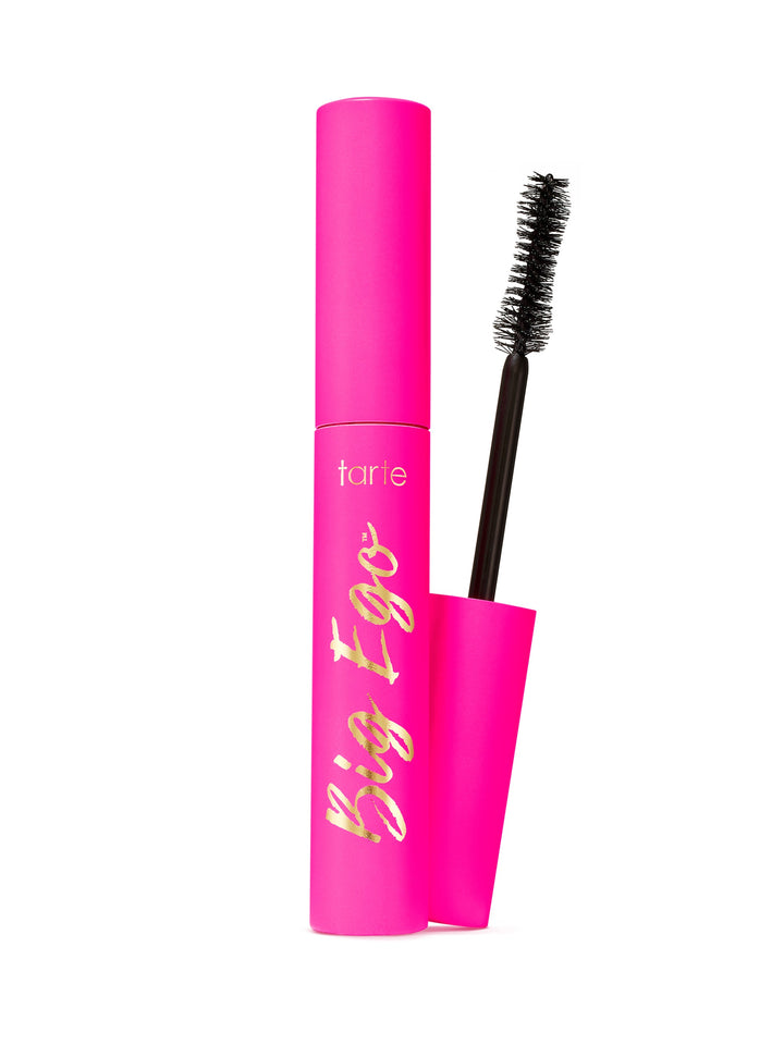 Pink mascara with black brush on a white background
