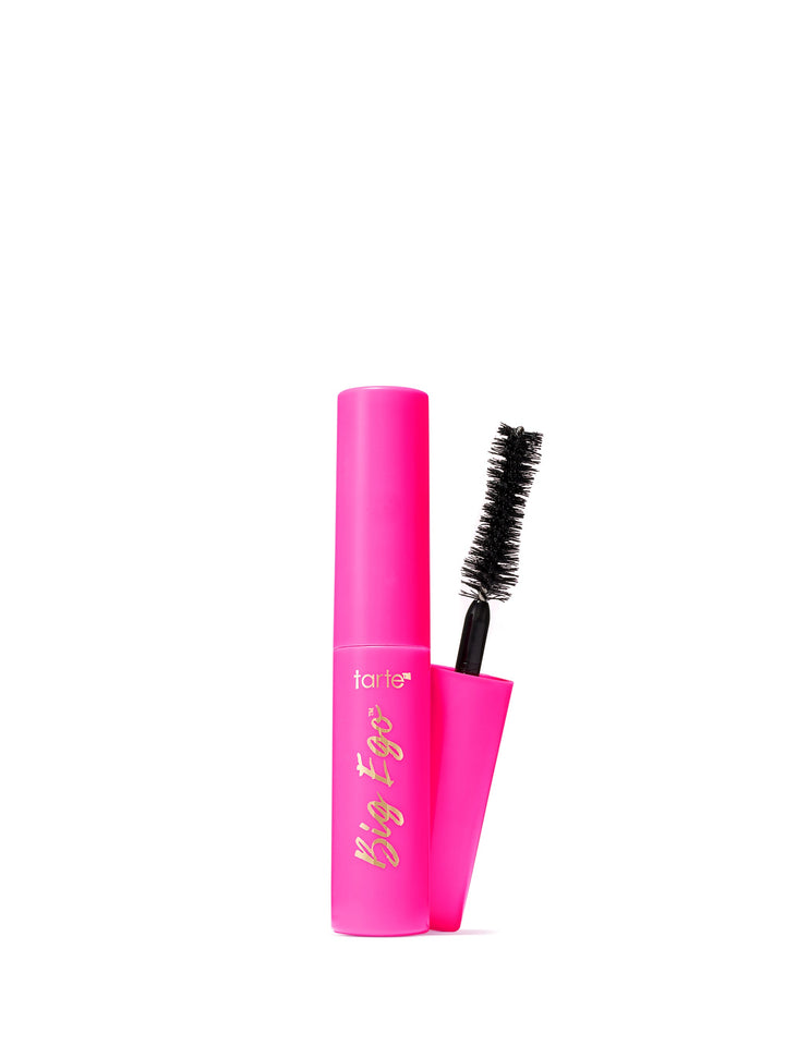 Pink mascara with black bristle brush on a white background