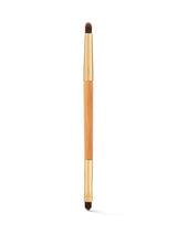 Makeup brush with wooden handle and black bristles on a white background