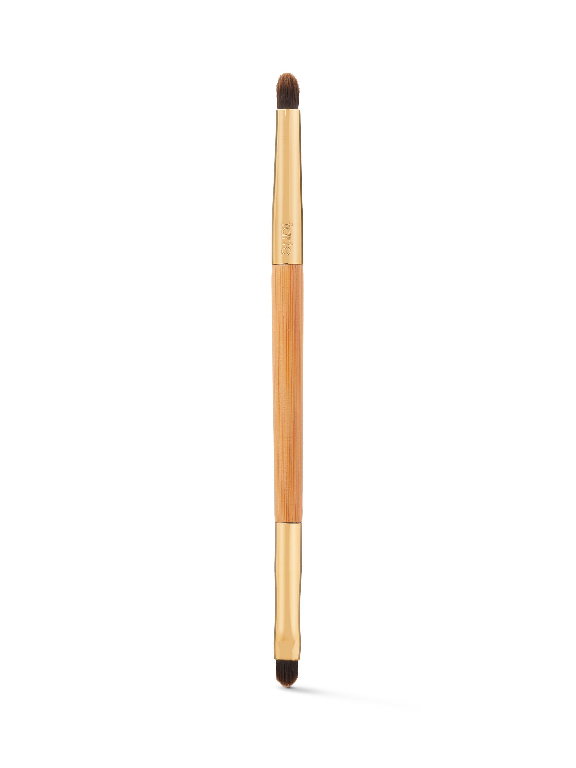 Makeup brush with wooden handle and black bristles on a white background