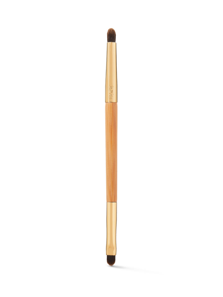 Makeup brush with wooden handle and black bristles on a white background