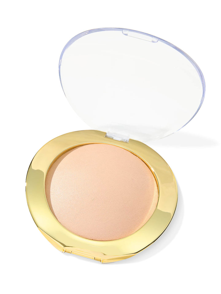 Compact powder in a gold case with a clear lid on a white background