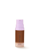 Tarte foundation bottle with pink cap on a white background