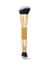 Makeup brush with gold handle and black bristles on a white background