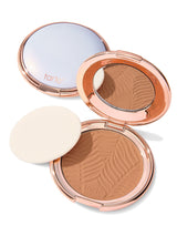 Compact powder with a zebra pattern and 'tarte' branding on a white background