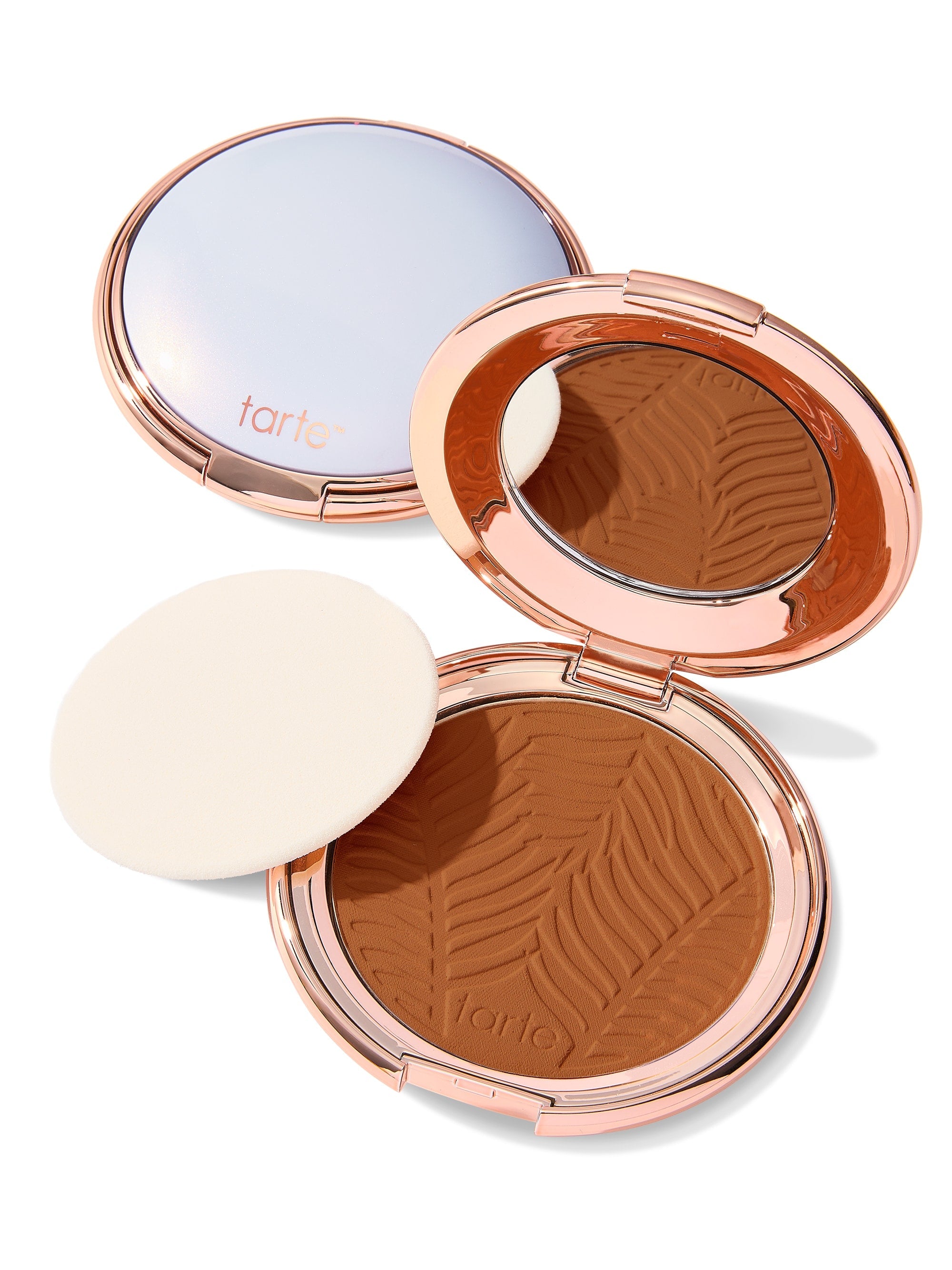 Compact powder with zebra pattern and 'tarte' branding on a white background