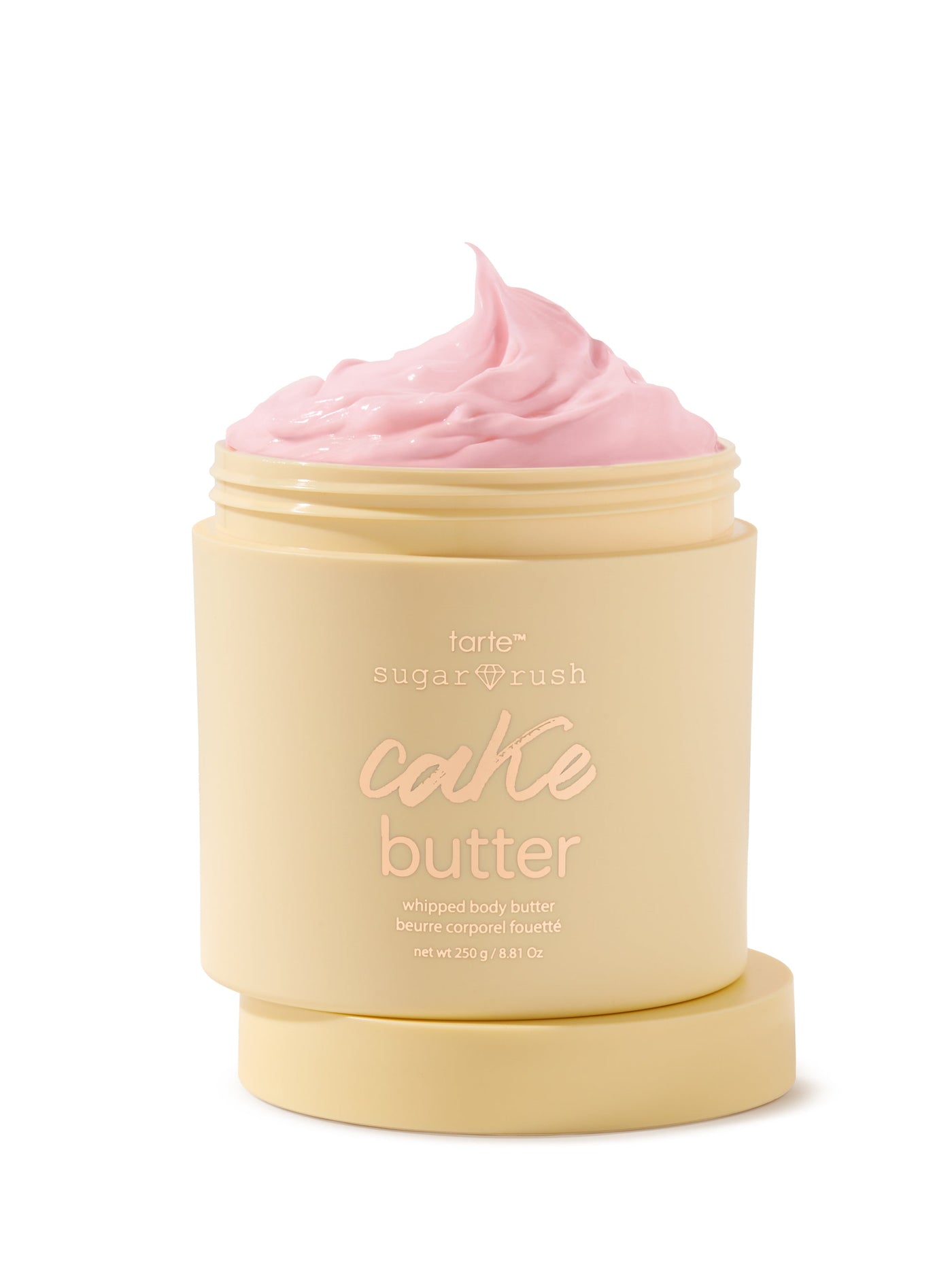 Jar of cake butter with pink whipped top on a white background