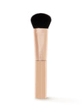 Makeup brush with black bristle head and beige handle on a white background