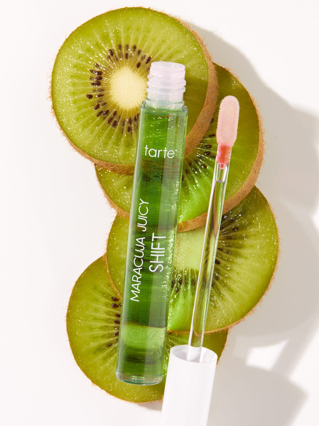 Tarte Maracuja Juicy Shot skincare product with kiwi slices on a white background