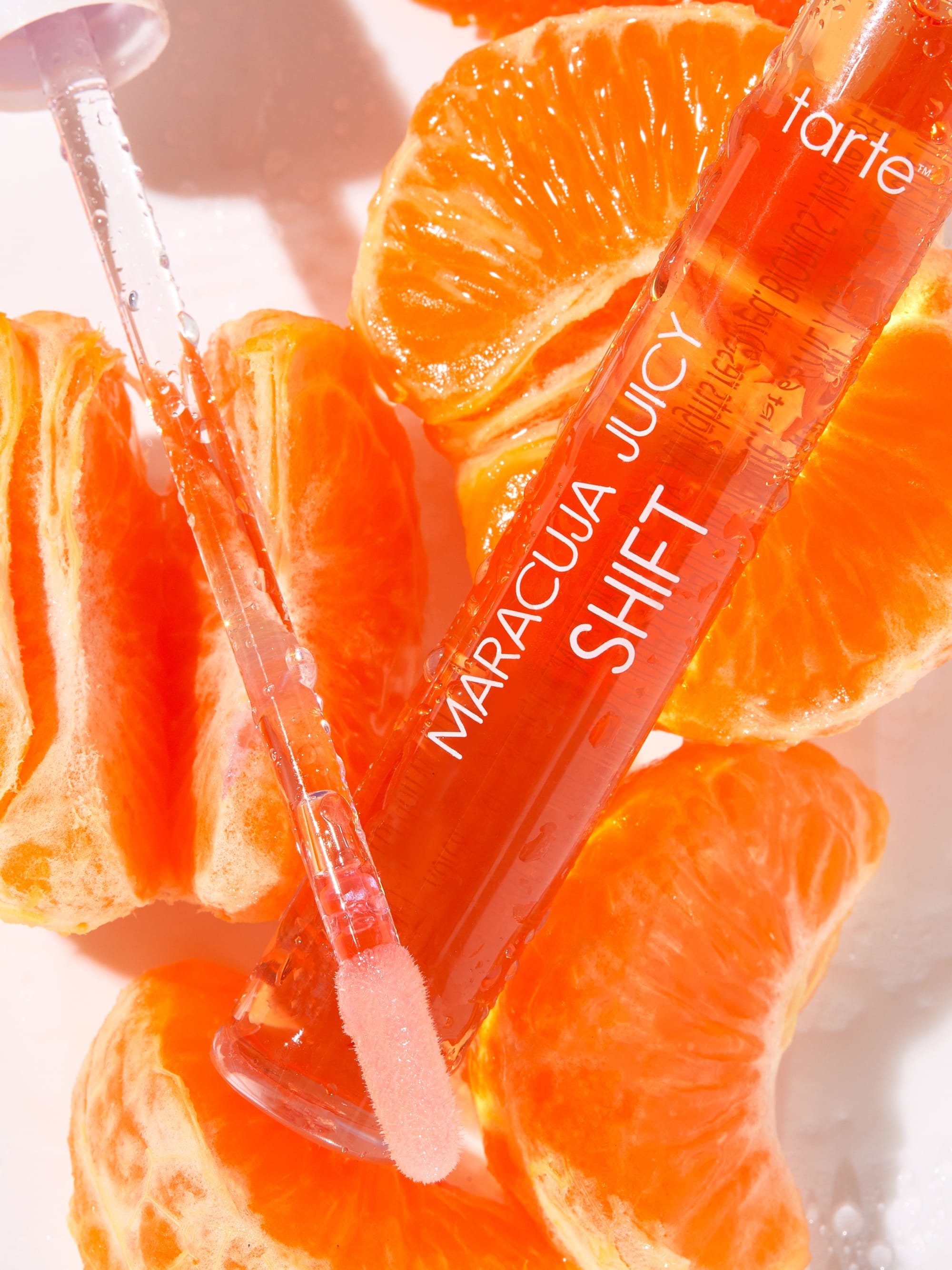Tarte Maracuja Juicy Shift product with orange slices on a white background