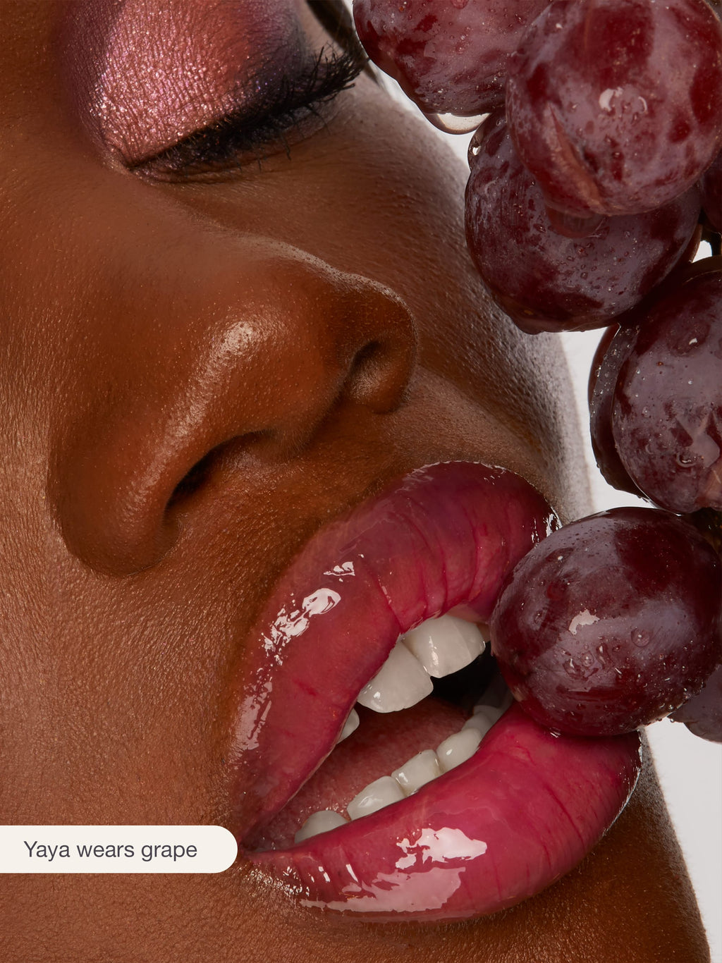 Close-up of a person with grapes near their face, with 'Yaya wears grape' text.